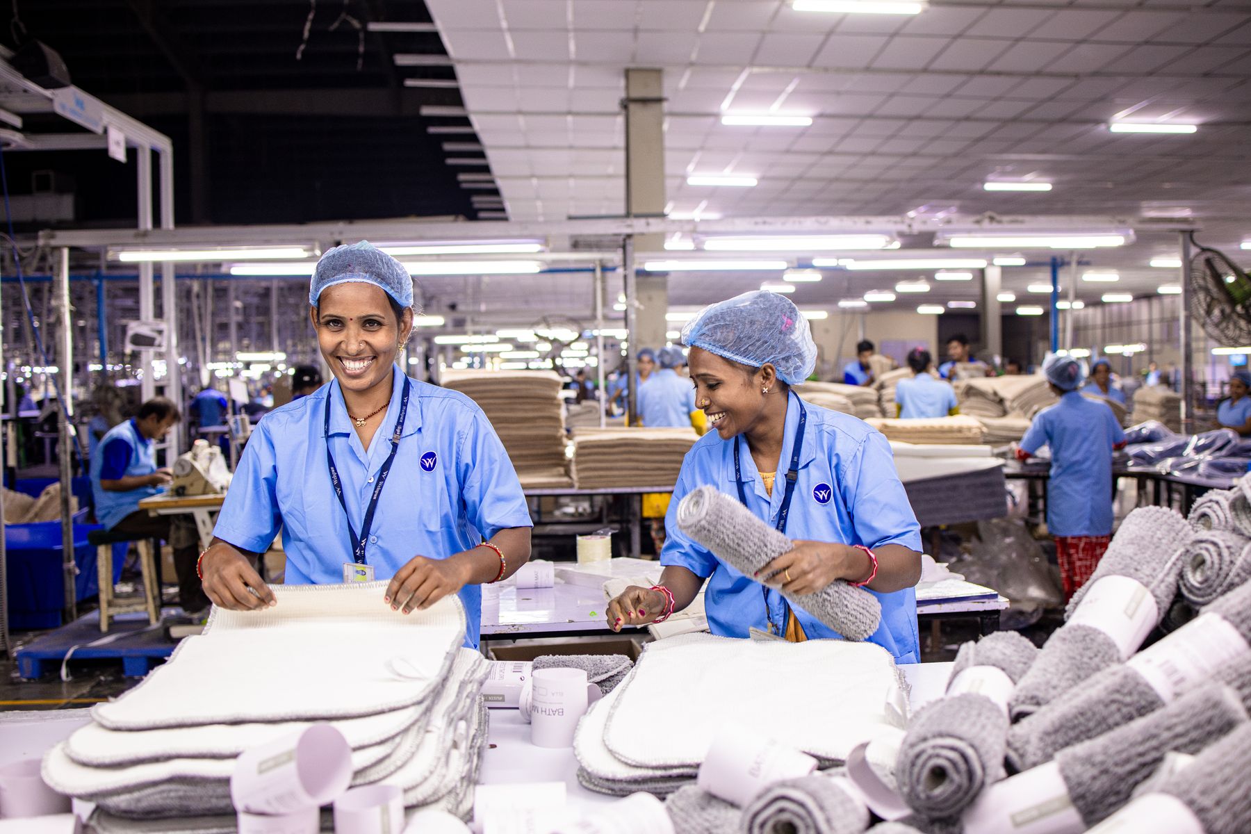 Production workers carrying out careful hand packing work